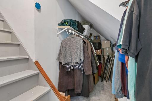 Second upper level bedroom has large walk-in closet with stairs to unfinished attic.