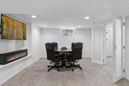 Fantastic family room with BRAND NEW carpet, new block windows and an electric fireplace. French doors lead to the 5th bedroom.