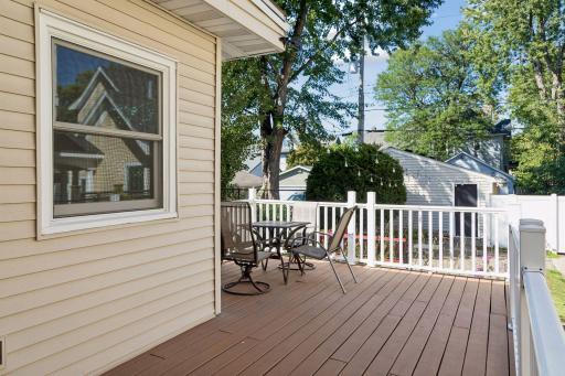 Walkout from kitchen to large rear deck overlooking the backyard.