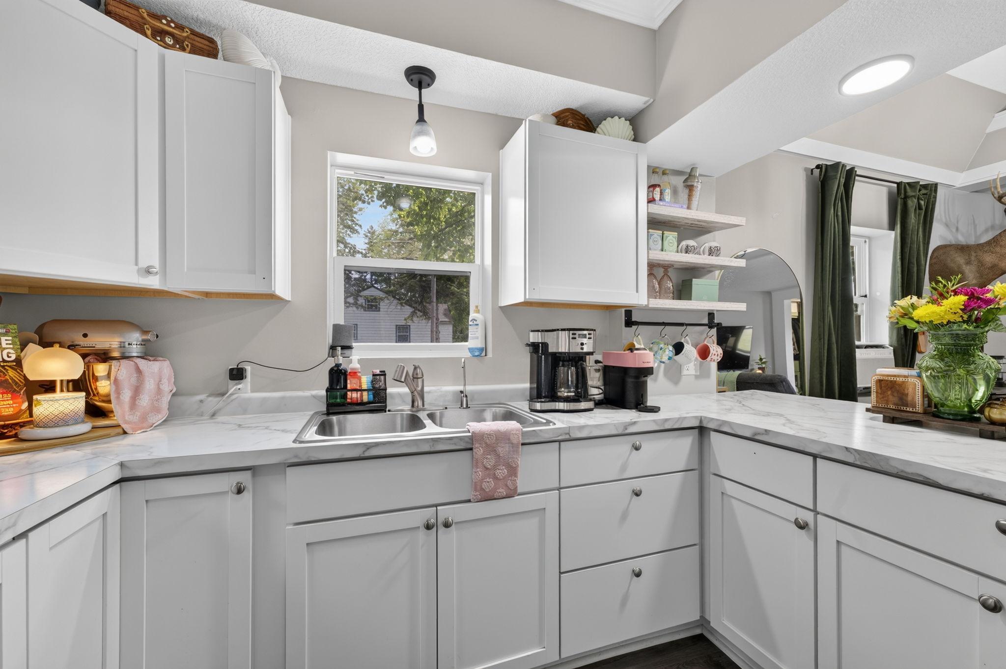 Functional kitchen with generous workspace and a window above the sink bringing in natural light.