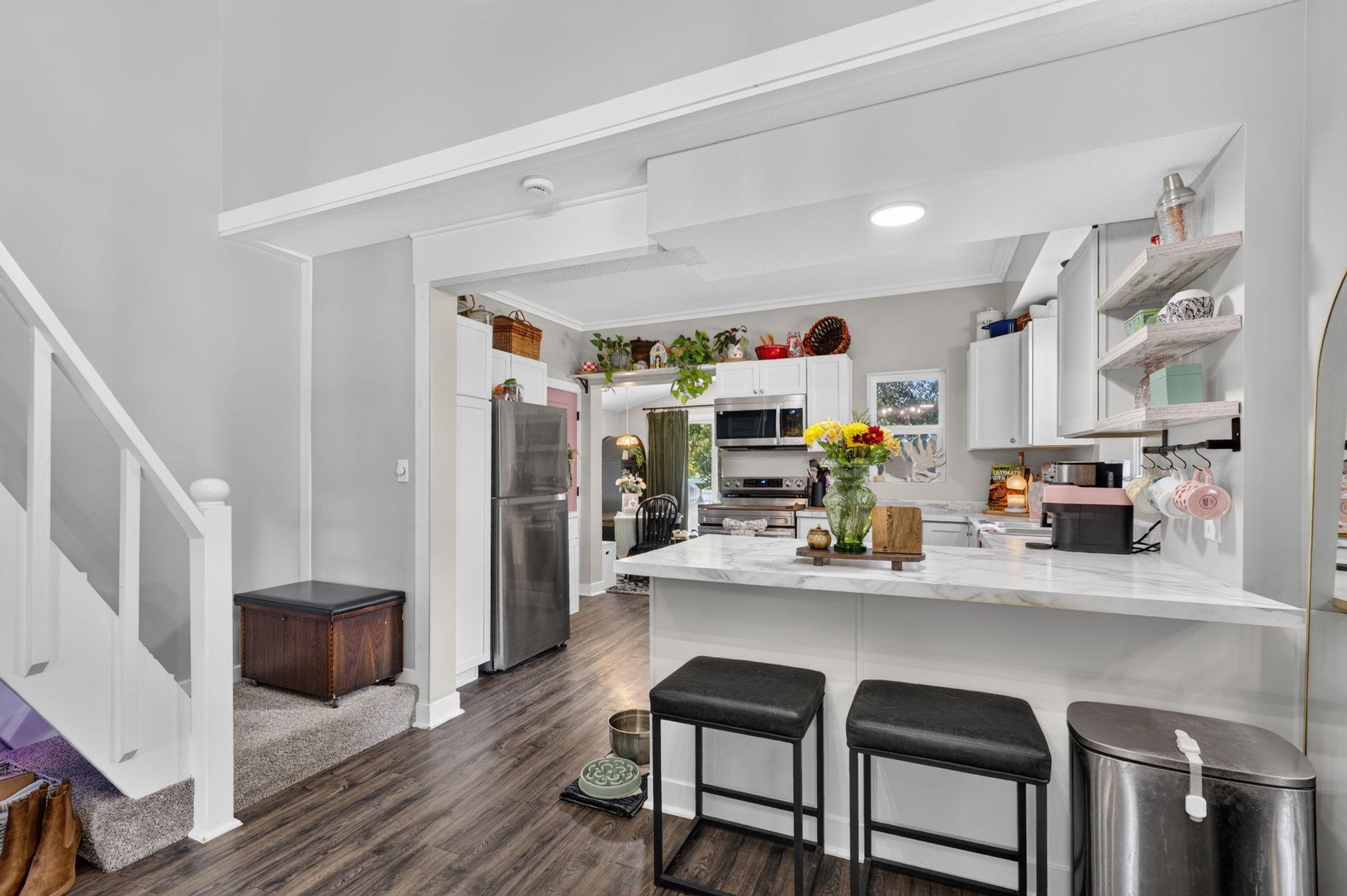 Vinyl plank flooring and a thoughtfully designed floor plan create a seamless flow throughout the home's main living spaces.