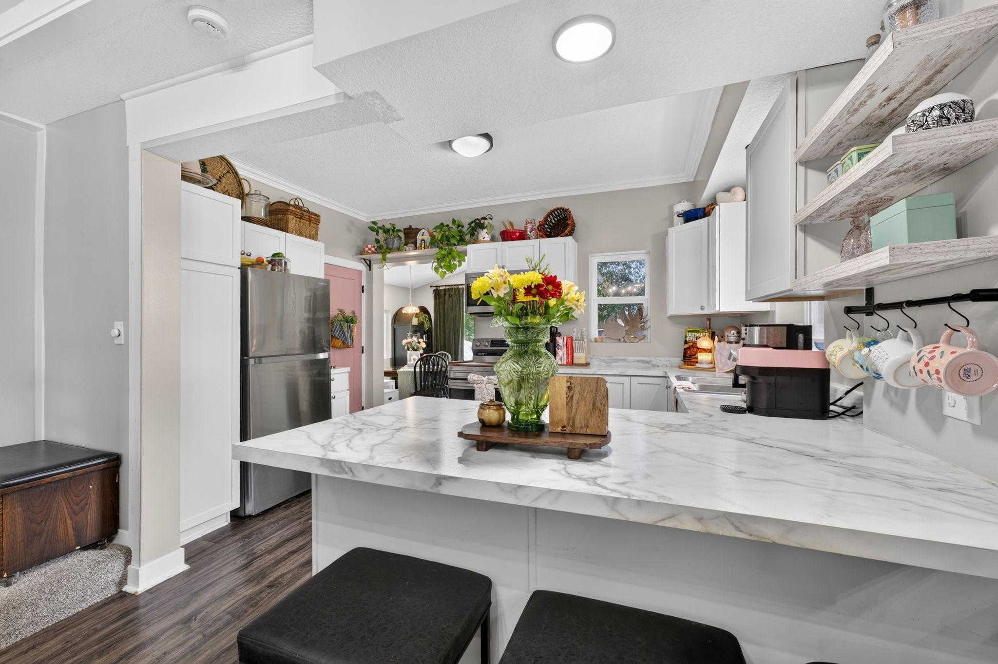 Kitchen features a breakfast counter perfect for casual dining, extra workspace, or chatting with the cook.