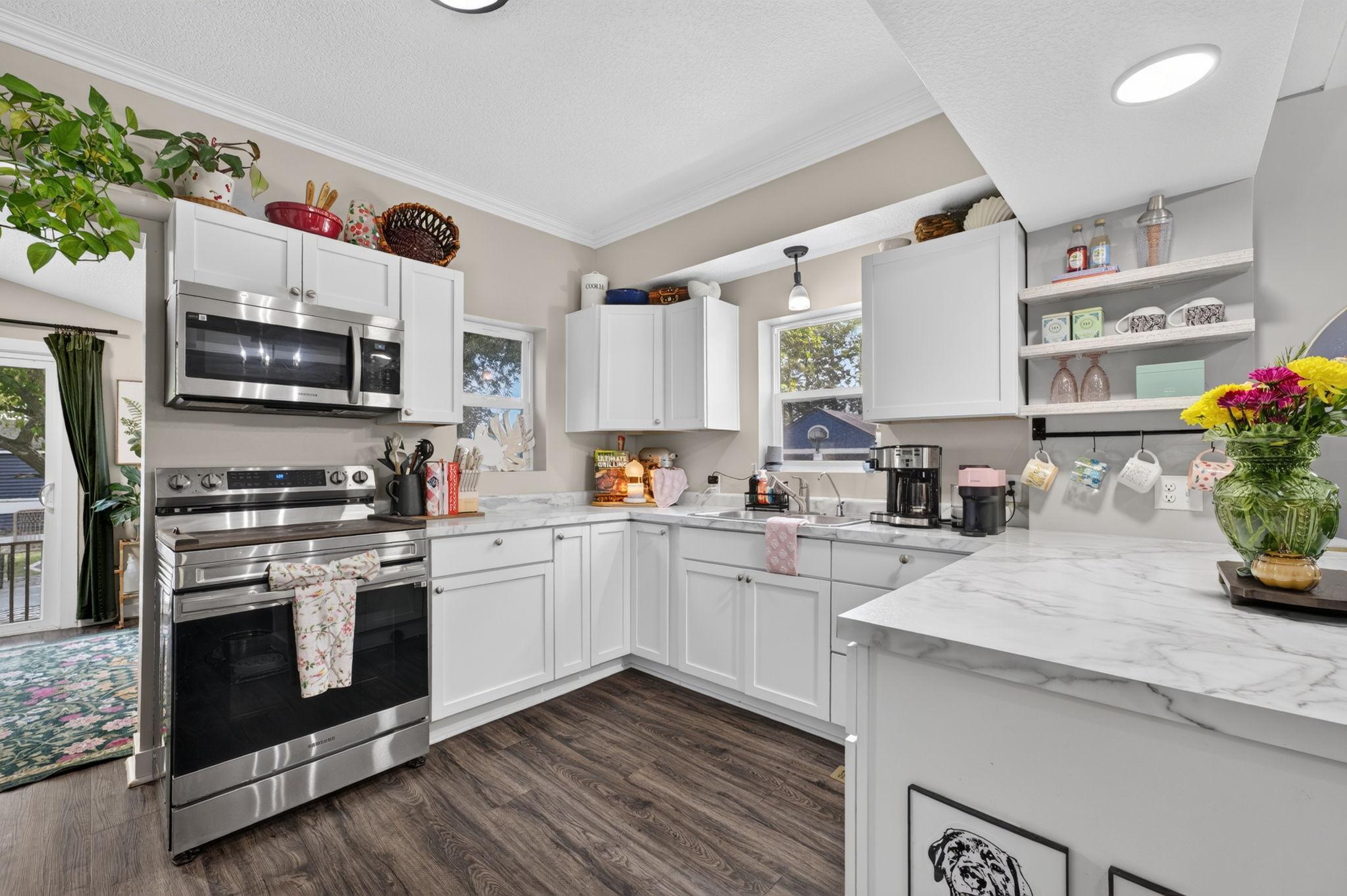 Updated kitchen with plenty of cabinet space, generous work surfaces, and natural light.