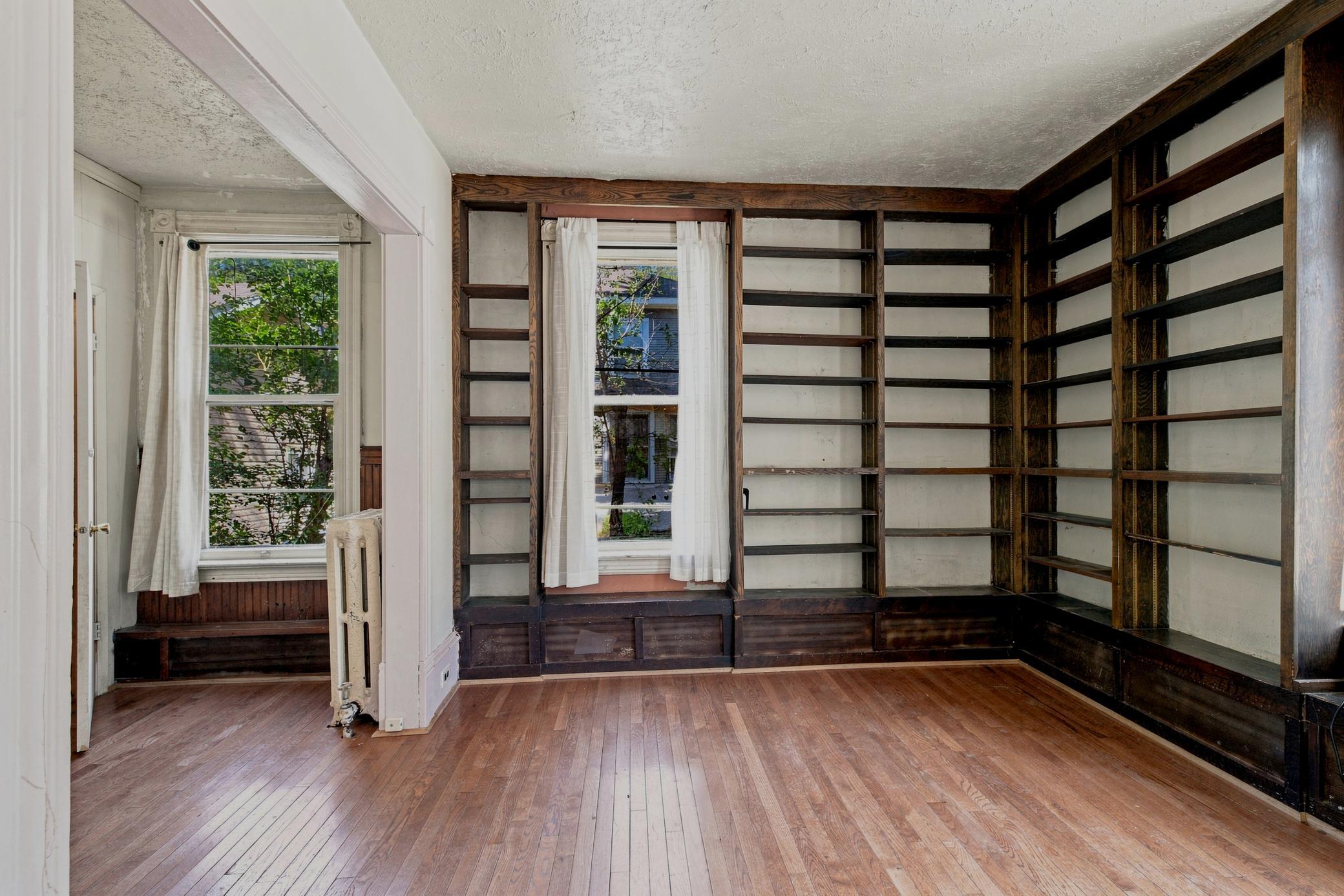 Floor to ceiling bookshelves, large windows, originaly moldings