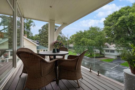 main level deck off of sunroom, composited decking, glass rails for maximum views