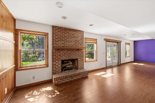 Wood-burning fireplace creates a cozy focal point.