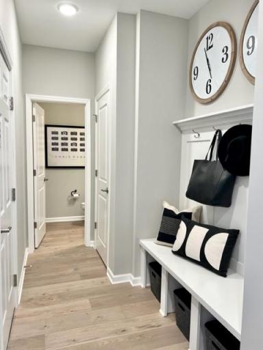 *ALL FURNISHED PHOTOS ARE OF MODEL OF SAME PLAN* Entrance from Garage, Boot Bench and Powder Room