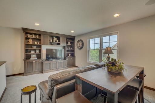 Upstairs, a loft with custom built-ins offers an additional living area alongside a second bedroom and bathroom.