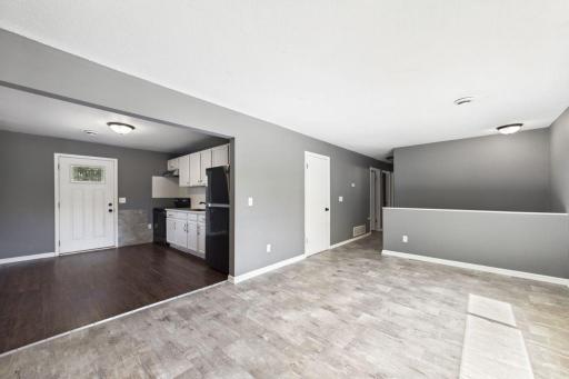 Livingroom looking into kitchen and back door to deck
