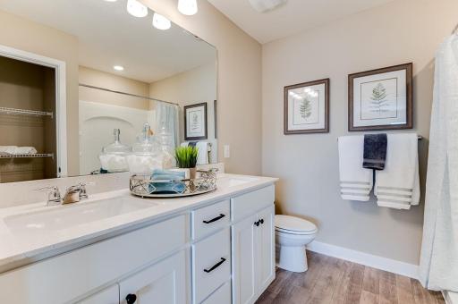 Primary suite comes with a private bath and walk-in closet. Pictures of model home colors and options will vary.