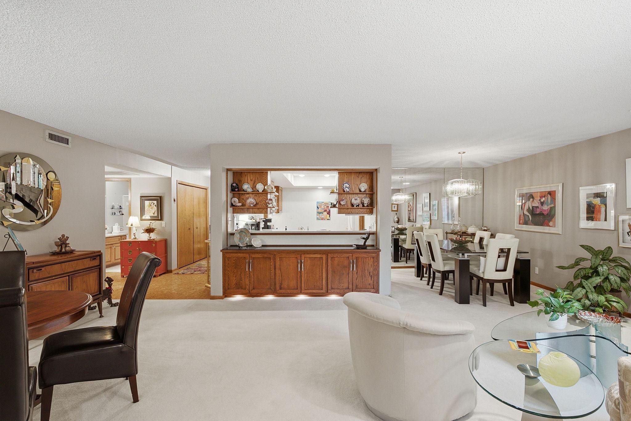 Open-Concept Living - A wide view showcases the home's spacious layout, built-in cabinetry, dining areas, and convenient pass-through connecting the living room and kitchen.