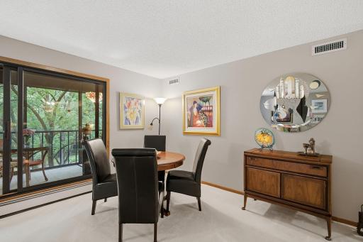 Informal Dining/Meeting Area - Multi-use area offers plenty of room for entertaining and enjoys a beautiful wooded view through the adjoining sunroom.