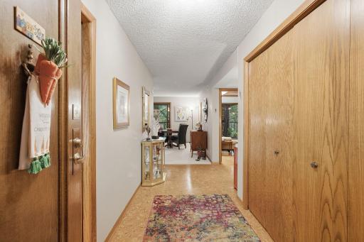 Entry Hall - A welcoming entry with warm woodwork and cork flooring leads into the home's open living spaces, with generous closet storage conveniently located nearby.