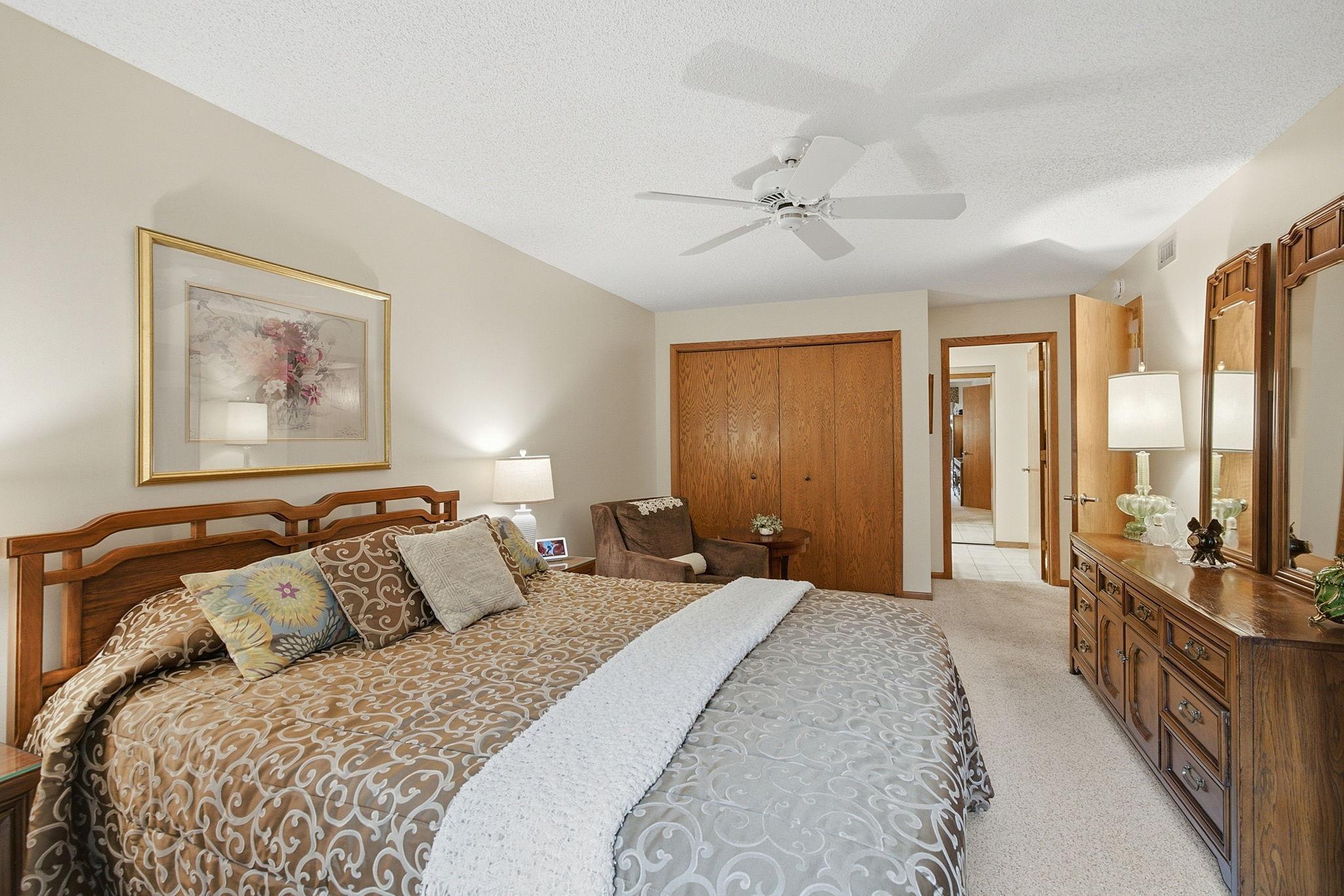 Primary Bedroom - Another view shows the generous proportions of the primary bedroom, including a large closet and convenient access to the adjoining dressing and bath area.