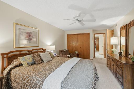 Primary Bedroom - Another view shows the generous proportions of the primary bedroom, including a large closet and convenient access to the adjoining dressing and bath area.