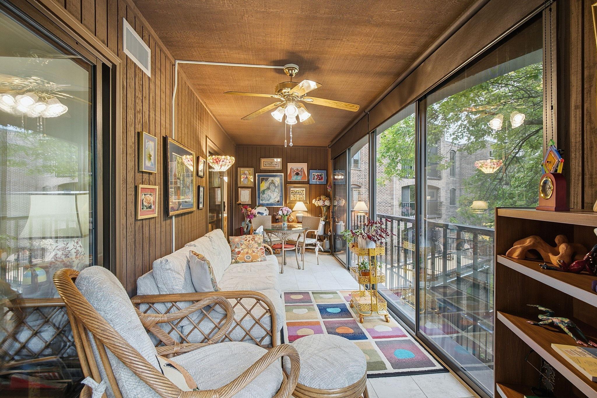 Three Seaons Sunroom - Another angle shows the impressive size of this screened outdoor living area, offering space for multiple seating arrangements and direct access from the condo.