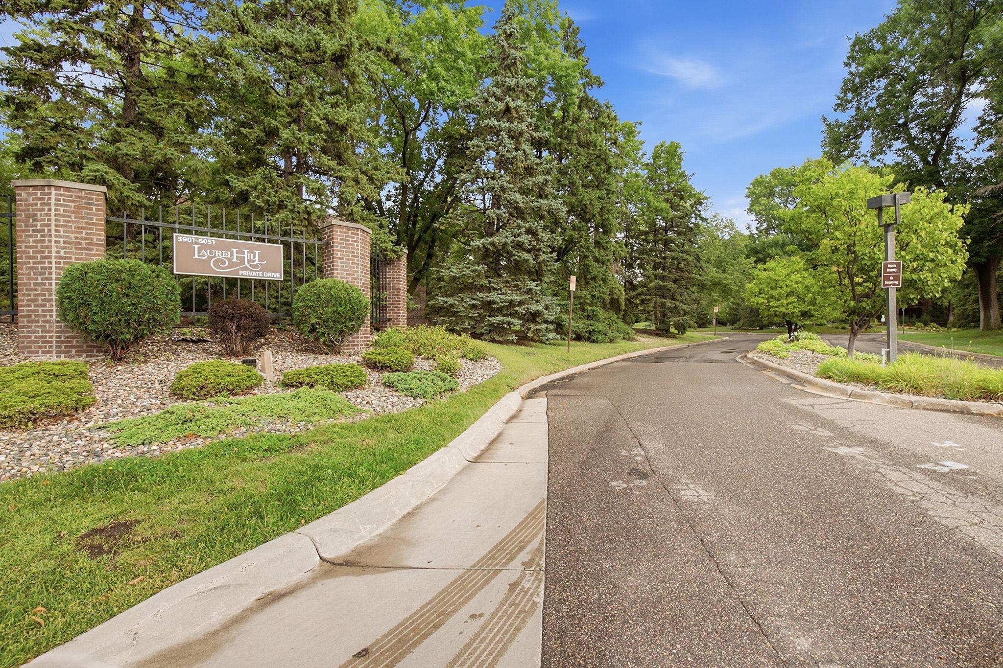 Laurel Hill Entrance - A welcoming approach to Laurel Hill West, surrounded by mature trees and established landscaping along the community’s private drive.