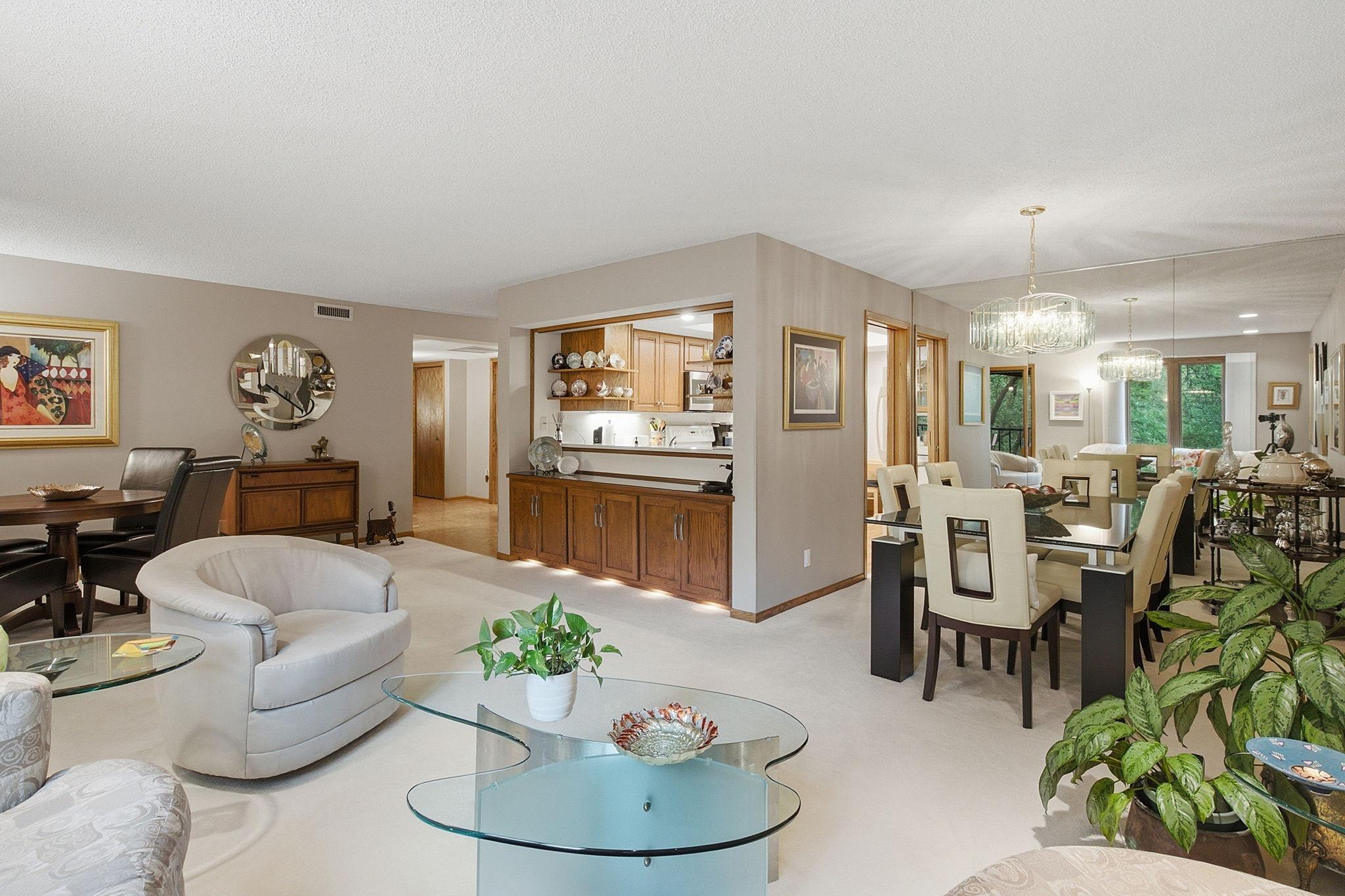 Open Living Space - Wide view showcasing the generous living and dining areas, built-in cabinetry, kitchen pass-through, and an open layout with plenty of room to gather.