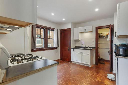 Kitchen offers plenty of cabinet and counter space, plus a convenient walk-in pantry.