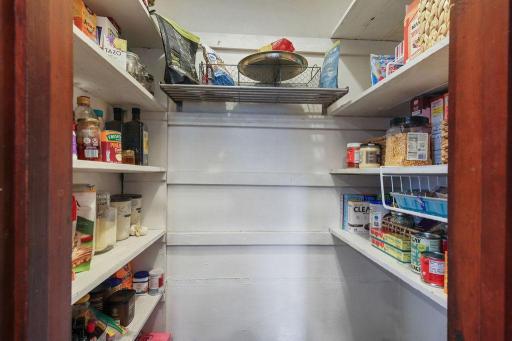 Walk-in pantry provides fantastic additional storage with shelving on three sides.