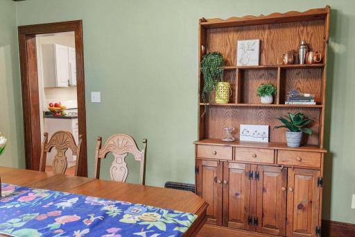 Another view of the formal dining room, highlighting the hardwood floors, natural woodwork, and abundance of natural light.