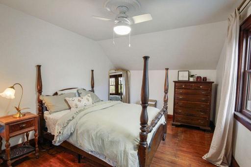 AnotherSpacious upper-level bedroom 1 with hardwood floors, and original woodwork.