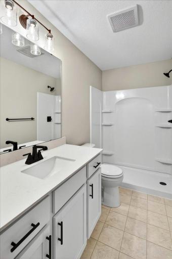Private Primary Bathroom. Photo taken of another home with similar plan and finishes.