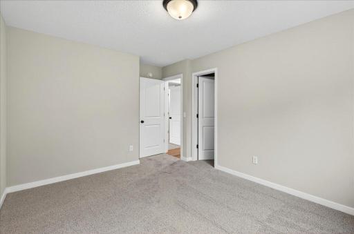 Bedroom 3. Photo taken of another home with similar plan and finishes.