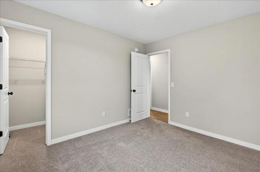 Bedroom 2. Photo taken of another home with similar plan and finishes.