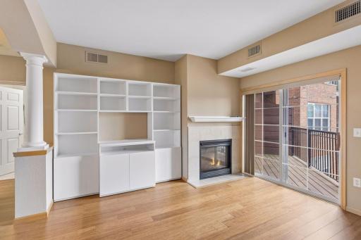 Living room with gas fireplace and built in shelves and cabinets