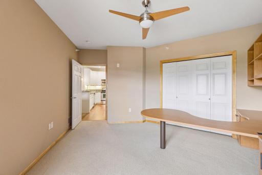 2nd bedroom, paneled doors, built in desk and organizer and a murphy bed