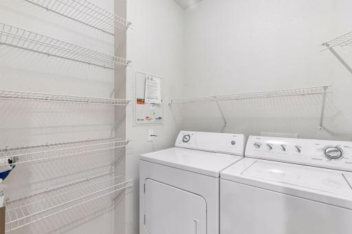 Nice size laundry room with storage racks n shelves, off the kitchen