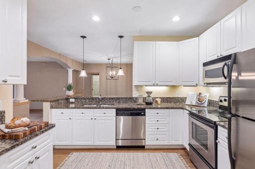 Stainless appliances, bamboo flooring, granite counters, bright and cheery