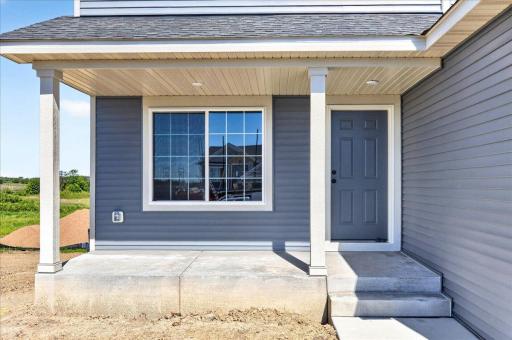 PHOTO OF A DIFFERENT HOME WITH SIMILAR PLAN. Spacious Concrete Front Porch. Sod, Irrigation System, and Front Plantings included and not shown in photo.