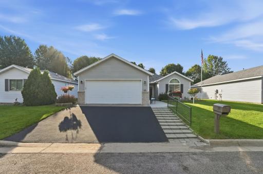 Beautiful curb appeal with a freshly tarred driveway.