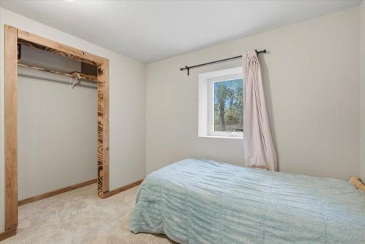 3rd bedroom, located in the lower level has a large window and closet with brand new carpeting