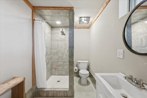 The attached ensuite in the lower level with the large room which could be a bedroom if a closet is added