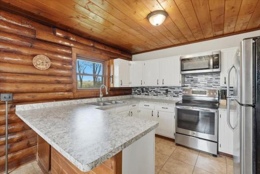 A kitchen refresh has this kitchen looking bright with ample counter space, newer appliances and open to the dining and living spaces