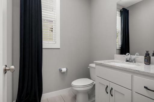 Main-level powder room with bright finishes and a clean, contemporary design.