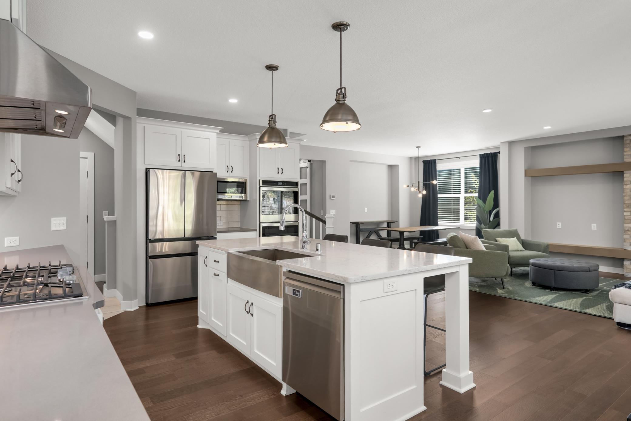 Another view of the spacious main level showcasing the seamless flow between the kitchen, living, and dining areas.