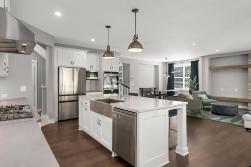 Another view of the spacious main level showcasing the seamless flow between the kitchen, living, and dining areas.