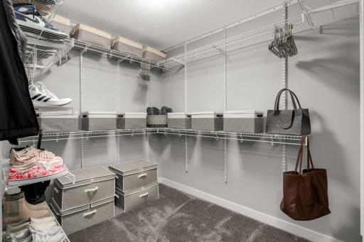 Large walk-in primary closet provides extensive shelving and hanging space.