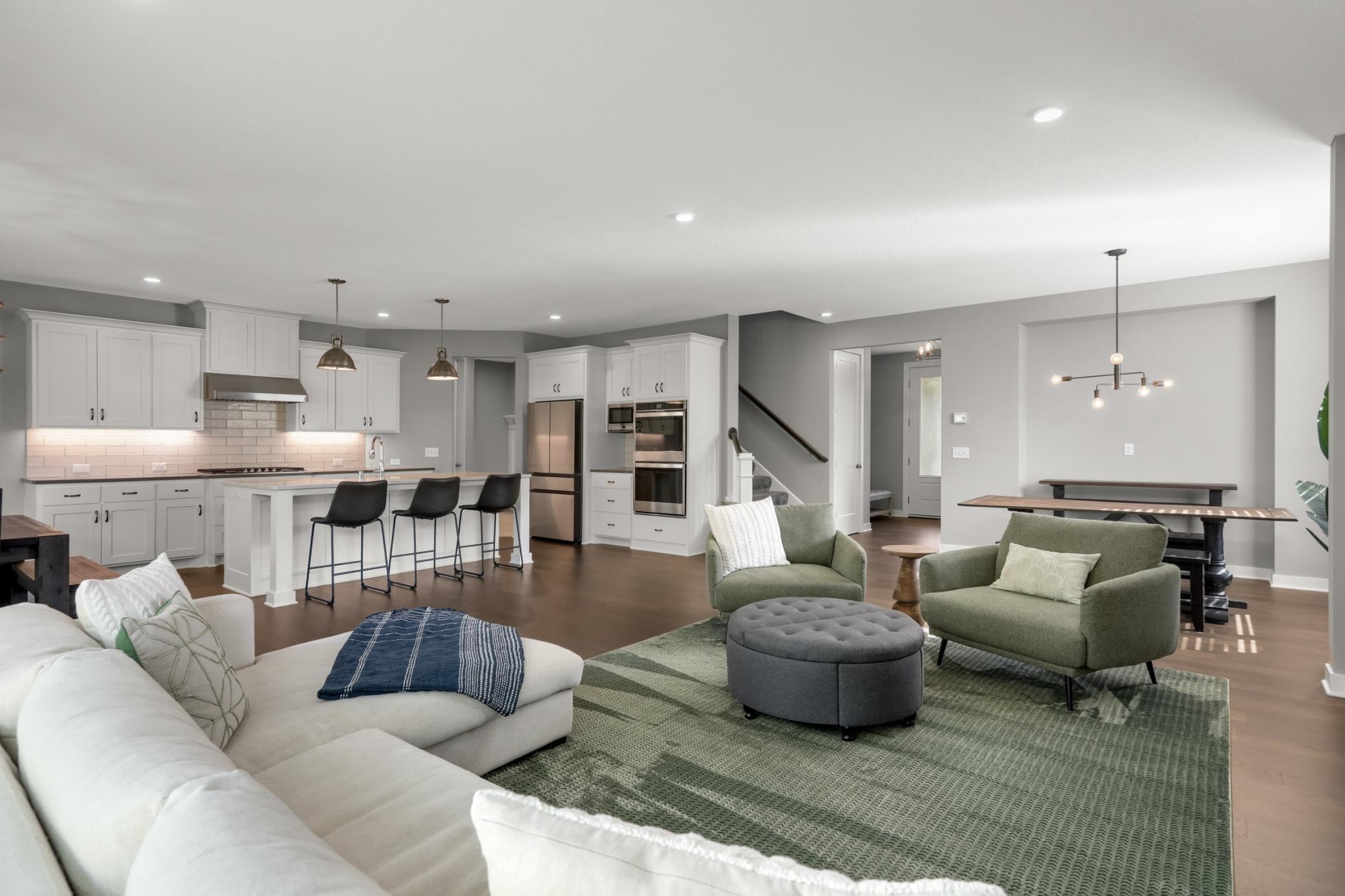 Expansive open-concept main level connects the living room, dining area, and kitchen.