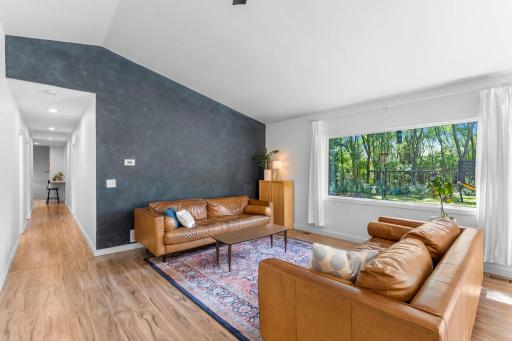 The main level welcomes you with generous living and dining spaces, south-facing windows that fill the rooms with natural light, and a 10-ft ceiling in the living room that gives the entire space an airy, expansive feel.