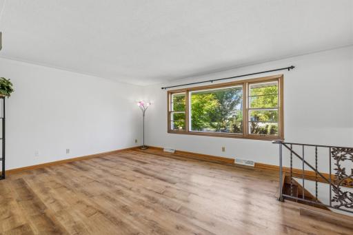 The Living Room in the upper level has a picturesque window that lets the natural light to flood the area.