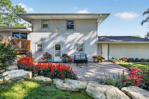 The brick patio with flowers (perennials and annuals) surrounding it. There's a door access from the main level and from the garage service door. The deck is just next to it.