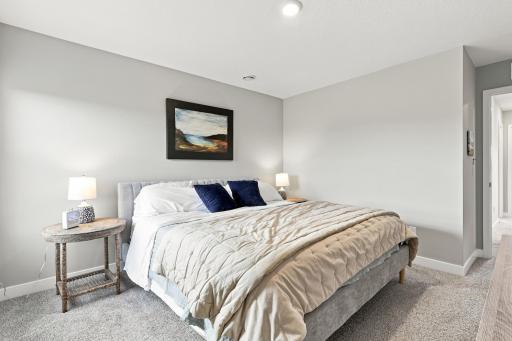 Upper level primary bedroom with ensuite bathroom and walk in closet. Bedroom overlooks the backyard which looks over the wetlands