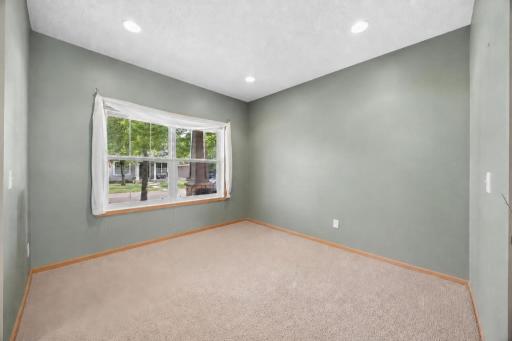 Front study/flex room has views of the charming front porch