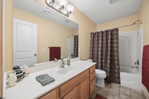 Convenience meets functionality in the lower-level full bath, featuring a spacious tub/shower combination and excellent storage for daily essentials. A comfortable and practical addition to the finished lower level.