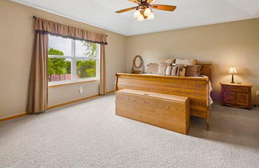 Primary bedroom offers generous space to relax from the day, including a sitting area and private primary bathroom suite access